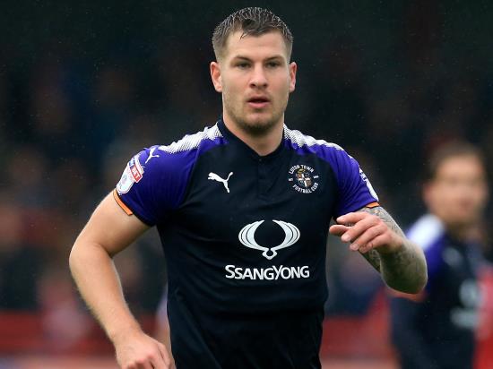 Runaway leaders Luton shrug off red card to win at Grimsby