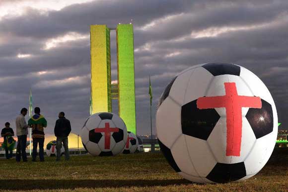Anti-World Cup protesters inflate giant footballs in Brasilia
