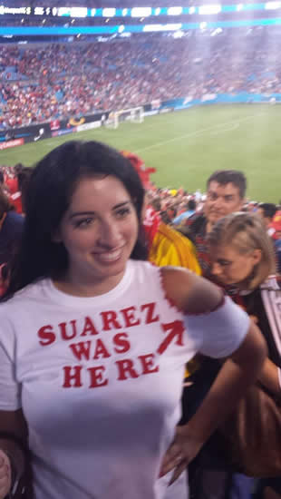 Liverpool footy fan shows off her new “Suarez was here” T-shirt, complete with bite marks