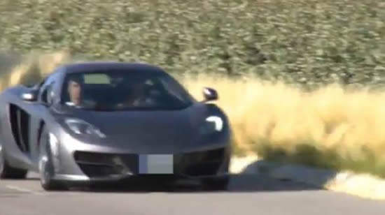 Cristiano Ronaldo drives past fans in ridiculously flashy McLaren sports car