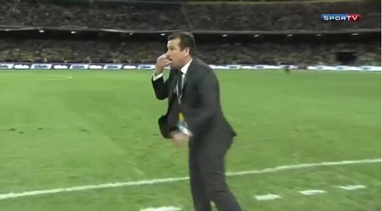 Brazil coach Dunga performs a “cocaine nose” gesture to an assistant on the Argentina bench
