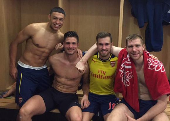 Aaron Ramsey posts a celebratory topless team photo from Arsenal dressing room