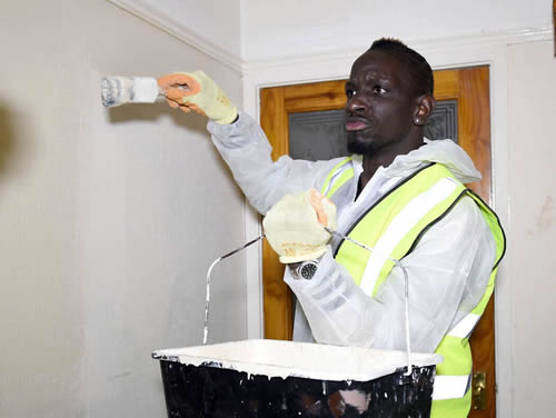 Liverpool's Mamadou Sakho volunteers for a local charity to restore a house