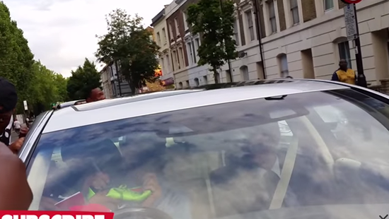 Arsene Wenger mobbed by Arsenal fans in his car, signs a Nike boot