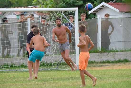 Gianluigi Buffon takes time out of holiday to play football with local kids in park