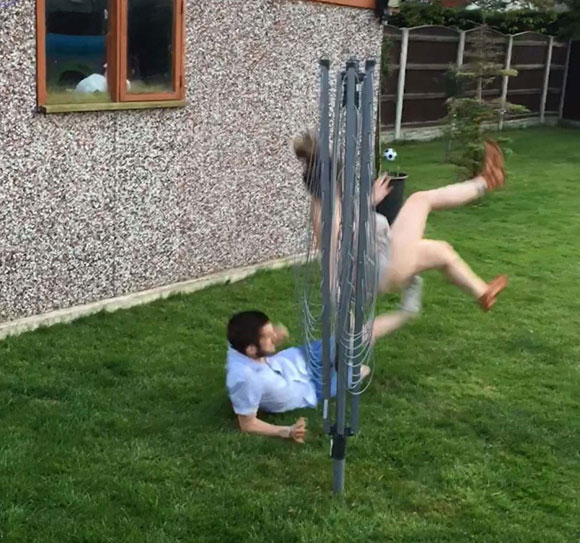 TOUGH LOVE Boyfriend leaves his girlfriend in a heap with brutal two-footed lunge during kickabout in his mum's garden