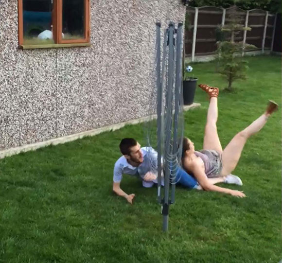 TOUGH LOVE Boyfriend leaves his girlfriend in a heap with brutal two-footed lunge during kickabout in his mum's garden