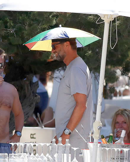 Liverpool boss Jurgen Klopp keeps his cool in daft umbrella hat and chills with a cigarette on holiday in sizzling Ibiza