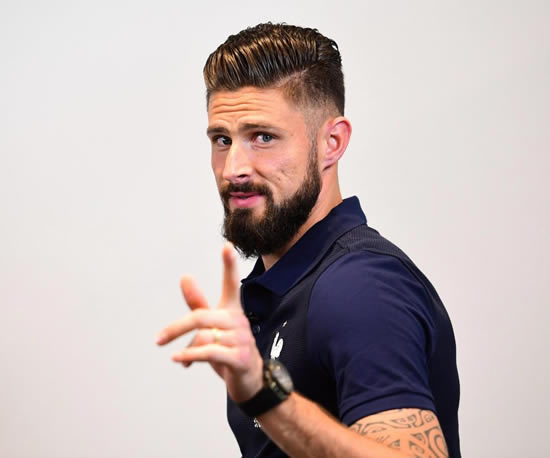Olivier Giroud is prepped and preened before a press conference at the French team's training base