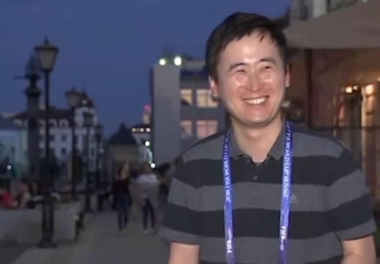 South Korean reporter Kwon Qwal Yel is kissed by two female fans during World Cup coverage