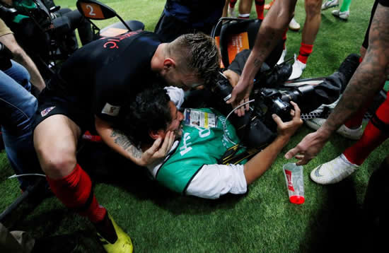Mario Mandzukic winning goal sees Domagoj Vida kiss a cameraman after he gets bundled in celebrations