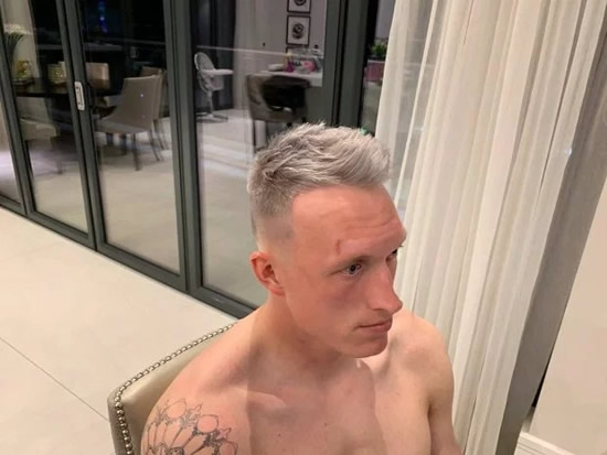Man Utd star Phil Jones looks shocked after seeing his drastic new silver hairdo