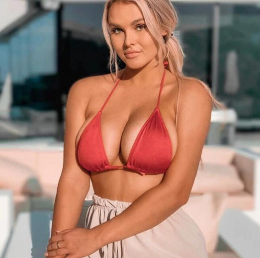 Kinsey Wolanski stuns in tiny red bikini while on Ibiza holiday break after Champions League invasion… as she sends fans signed copies of infamous strip