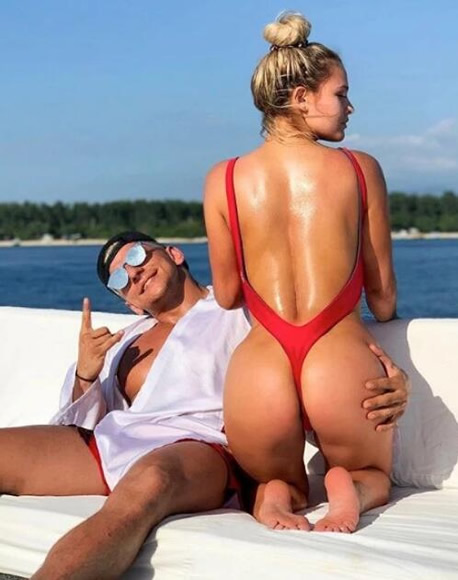Kinsey Wolanski stuns in tiny red bikini while on Ibiza holiday break after Champions League invasion… as she sends fans signed copies of infamous strip