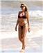Making waves ... Kelly Brook tops up her tan with a stroll in the Brazilian surf
