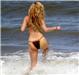 Off for a swim ... Brit model Kelly Brook flashes an impressive rear view