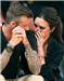 Above: Victoria and David Beckham couldn't take their eyes off each other as they whispered and giggled