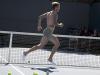 Golden balls ... David runs over a tennis court wearing nothing but pants and slippers