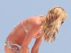 Sizzling ... sun-burnt Abbey peels off her denim shorts in Ibiza