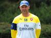 Steve Bould watches the Arsenal players train, with Arsene Wenger engaged in World Cup and transfer business