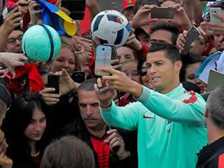  ME MYSELFIE AND I Euro 2016: Cristiano Ronaldo poses for selfies with Portugal fans as he forgets microphone mishap ahead of semi-final against Wales 