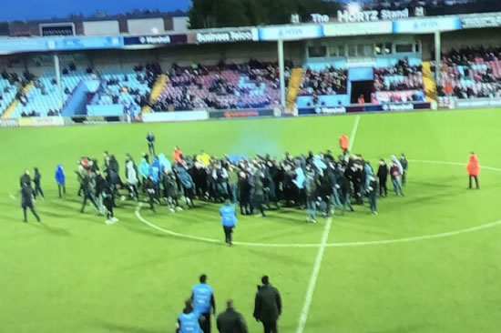 Non-league game suspended as fans invade pitch with flares protesting ownership