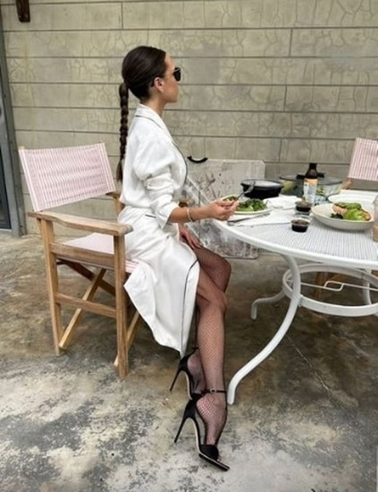 Victoria Beckham parades endless legs in nothing but fishnet tights and bath robe