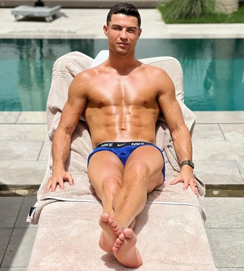 RIPPED RON Cristiano Ronaldo shows off his rippling six-pack as he sunbathes beside a swimming pool in Instagram post