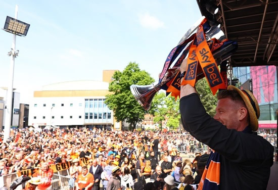MAD HATTERS’ GLEE PARTY Luton Town fans celebrate team’s Premier League promotion with open top bus parade