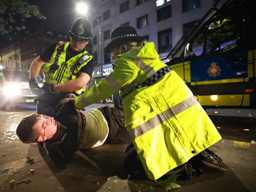 Manchester City fans smash up cop van and clash with riot police after side wins Champions League and completes treble