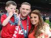 Family fun ... Wayne Rooney with heavily-pregnant Coleen and son Kai at Man Utd game earlier this month